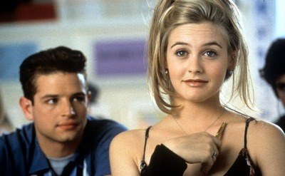 Alicia Silverstone appearing to be daydreaming while Justin Walker is gazing at her in the back, in a scene from the film 'Clueless', 1995.