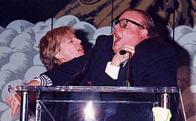 David Spade and Chris Farley are goofing around.