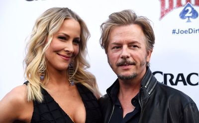 Brittany Daniel and David Spade pose for the press.