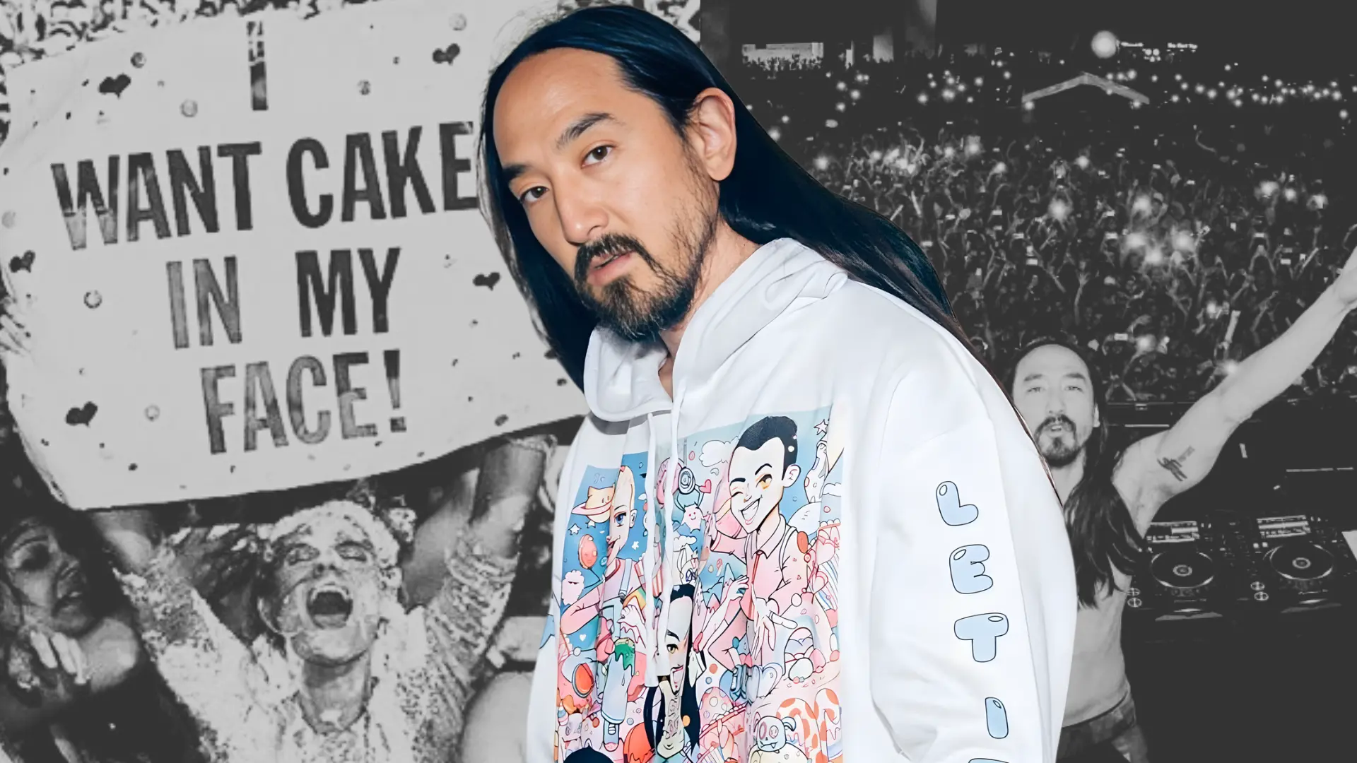 Steve Aoki in a white graphic hoodie stands before a crowd and a fan holding a sign that says I want cake in my face