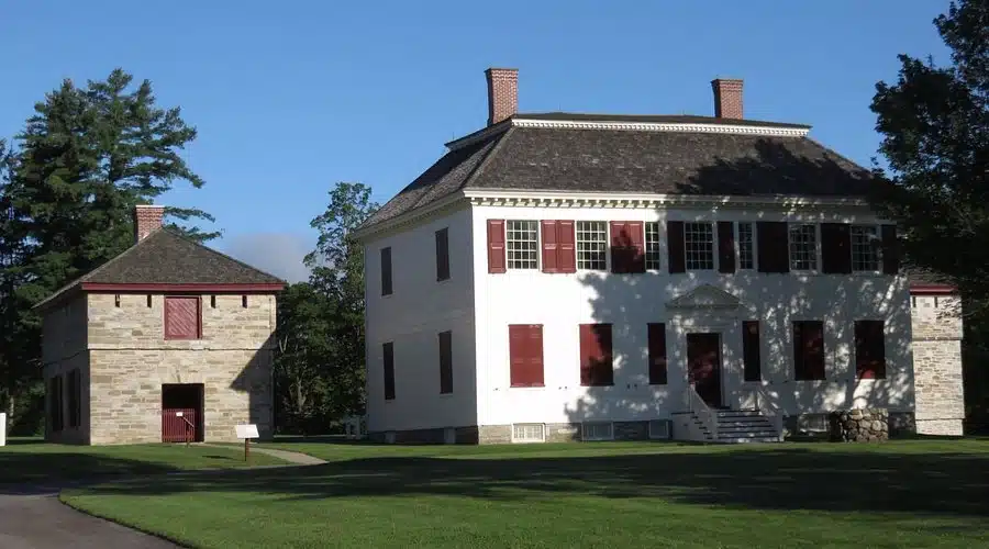 An image of the Johnson House Historic Site building on a sunny day and a green lawn infront of the building