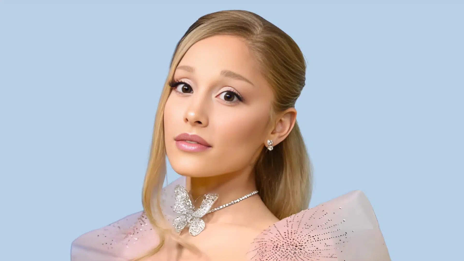 Portrait of Ariana Grande with blonde hair wearing a sparkling butterfly choker necklace against a light blue background