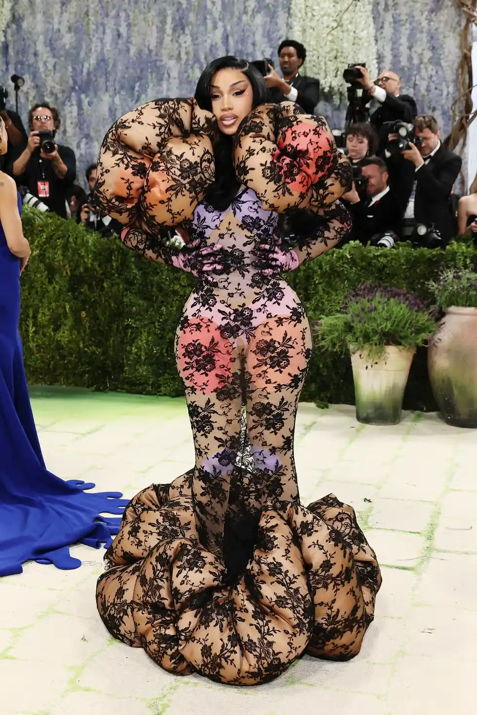 Cardi B poses in a Marc Jacobs surrealist look with massive heels inspired by Hans Bellmer mannequins
