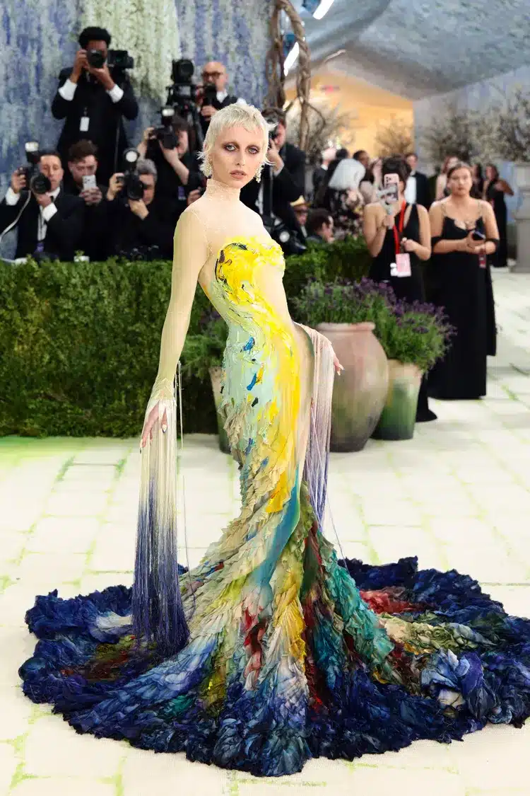 Emma poses in a custom Mugler gown featuring hand painted watery blue tones inspired by Impressionist art