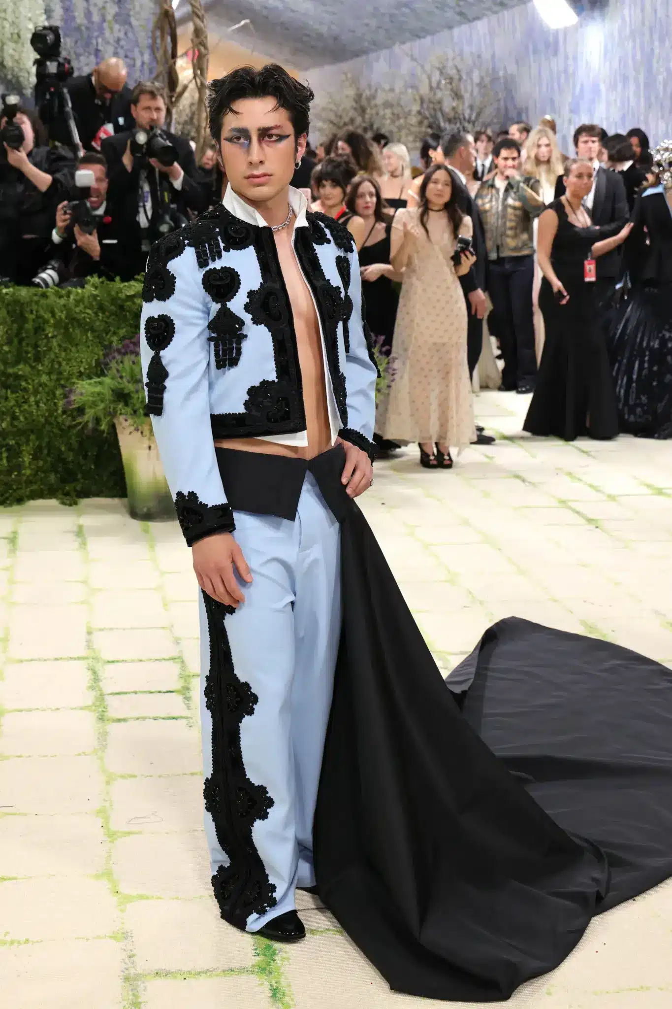 Hudson stands in a Balenciaga bolero jacket and gown with dramatic Black Swan inspired eye makeup