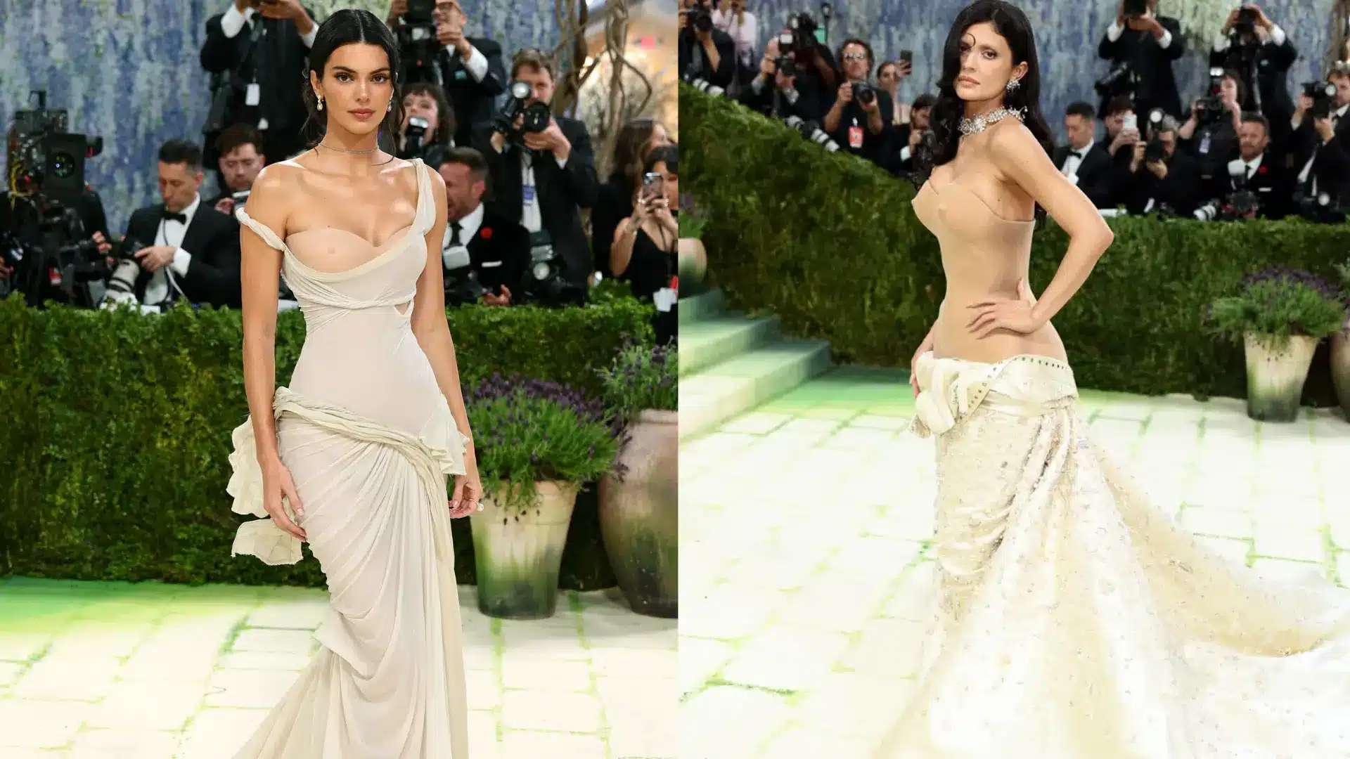 Two women wear cream gowns at a gala Kendall Jenner stands on the left while Kylie Jenner poses on the right side of it